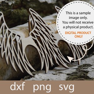 May include: A pair of wooden angel wings with intricate details, resting on a natural wood background. The image includes the text "This is a sample image only. You will not receive a physical product. DIGITAL PRODUCT ONLY" and the file formats "dxf png svg".