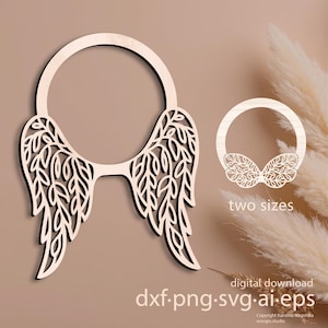 Puede incluir: Un diseño de alas de ángel de madera con un marco circular, con intrincados recortes en forma de hojas. La imagen incluye una versión más pequeña y el texto "two sizes" y "digital download dxf.png.svg.ai.eps".