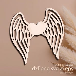 Puede incluir: Alas de ángel de madera clara con un corazón central. Las alas presentan intrincados detalles recortados. La imagen incluye el texto "descarga digital" y opciones de tipo de archivo.