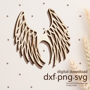 May include: A wooden cutout of angel wings with a detailed intricate design. The wings are light brown and have a natural wood grain. The image includes the text "digital download dxf.png.svg Copyright Karolina Nagorska woogie.studio".