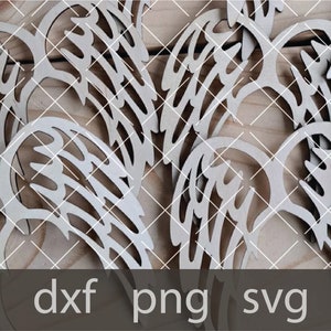 May include: A set of wooden angel wing cutouts, perfect for crafting projects. The wings are intricately detailed and have a natural wood finish.
