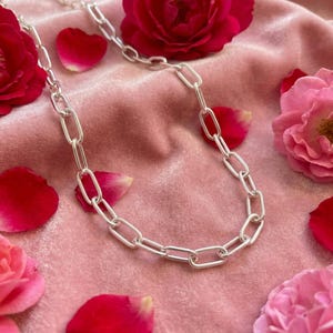 May include: A set of three ceramic mugs with a speckled, matte finish. The mugs are in shades of cream, light brown, and dark brown. Each mug has a simple, minimalist design, ideal for coffee or tea.