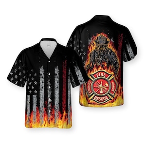 May include: Black button-up shirt with a firefighter theme. The front features a distressed American flag design with flames at the bottom. The back displays a firefighter in flames and a fire department emblem with the words "Courage, Honor, Rescue."