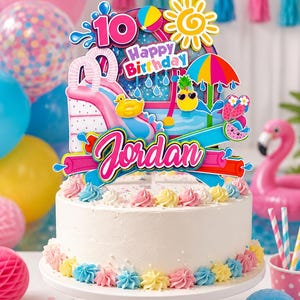 May include: A white frosted cake topped with a colourful pool-themed cake topper featuring the number 10, the text Happy Birthday, and the name Jordan. The topper includes illustrations of a pink slide, a yellow duck, a pineapple, and a beach umbrella.