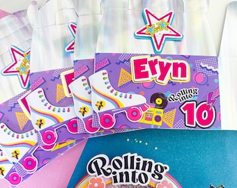 May include: Party favour boxes with a holographic sheen, featuring a roller skate design, the name "Eryn", and the phrase "Rolling into 10". The boxes have a purple and teal colour scheme with star accents, perfect for a birthday celebration.