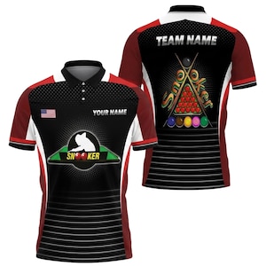 May include: A black and red polo shirt with a snooker theme. The front features a silhouette of a player, the word "SN00KER", and the American flag. The back displays a snooker ball rack, cues, and the words "TEAM NAME".