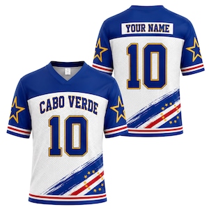 May include: A blue and white V-neck jersey featuring the text CABO VERDE and the number 10 on the front, with YOUR NAME and the number 10 on the back. The design includes yellow stars on the sleeves and a diagonal stripe with small yellow stars.