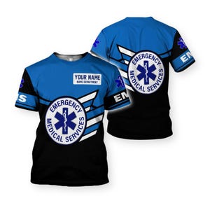 May include: A blue and black t-shirt with the words "EMERGENCY MEDICAL SERVICES" and a medical symbol. The shirt has a white wing design and a space for "YOUR NAME" and "NAME DEPARTMENT".