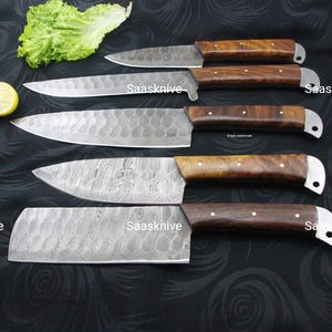May include: An assortment of five kitchen knives with wooden handles and textured steel blades. The blades have a unique pattern. The handles are a dark brown color with silver accents. The word "Saasknive" is printed on the blades.