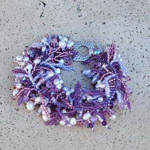 Purple and pink pearl and crystal bracelet with a beaded base