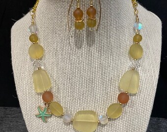 Gold and yellow single-strand Necklace with an enameled aqua starfish charm and matching dangle earrings.
