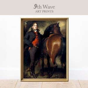 May include: A painting of a man in a black coat and red vest standing next to a brown horse. The man is holding a riding crop in his right hand. The painting is framed in gold.