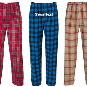 May include: Three pairs of plaid pajama pants with different color combinations. The pants are all made of a soft, comfortable fabric and have an elastic waistband. The pants are personalized with the text "Your text here".