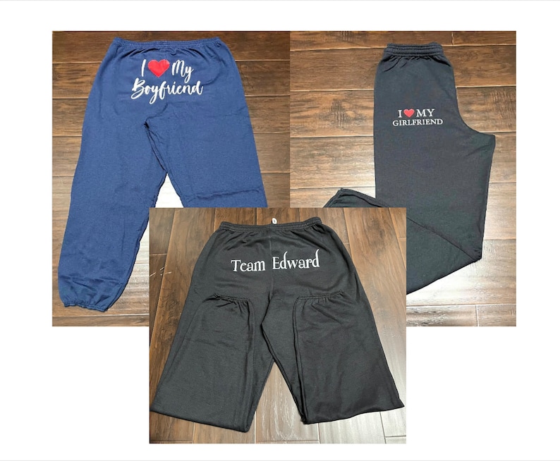 May include: Three pairs of black sweatpants with different text printed on the back. One pair says "I love my boyfriend", another says "I love my girlfriend", and the last pair says "Team Edward".