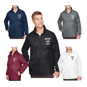 May include: A collection of lightweight jackets in navy blue, black, gray, burgundy, and white. Each jacket features a full zipper, a stand-up collar, and the text "CUSTOM LOGO TEXT" printed on the chest. The jackets are designed for outdoor wear.