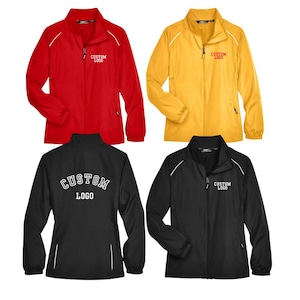 May include: Four lightweight jackets in red, yellow, and black. Each jacket has a zipper closure, white piping, and the text "CUSTOM LOGO" printed on the front or back. The jackets are designed for outdoor activities.