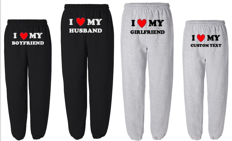 May include: Four pairs of black and gray sweatpants with a red heart and the text "I love my" followed by different words. The words are "Boyfriend", "Husband", "Girlfriend", and "Custom Text".