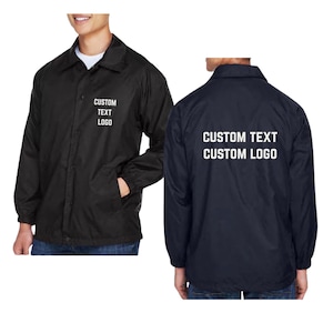 May include: A black coach jacket featuring a collar, snap-button front closure, and long sleeves with elastic cuffs. The front left chest displays the text CUSTOM TEXT LOGO, while the back features the text CUSTOM TEXT CUSTOM LOGO in white.