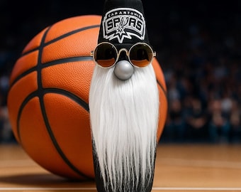 May include: A whimsical gnome wearing a black hat with the San Antonio Spurs logo and gold-rimmed sunglasses. The gnome has a long white beard and a silver nose, set against a basketball and a blurred background of a basketball court.