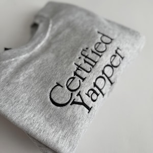 May include: A grey sweatshirt with the text "Certified Vapper" embroidered in black.