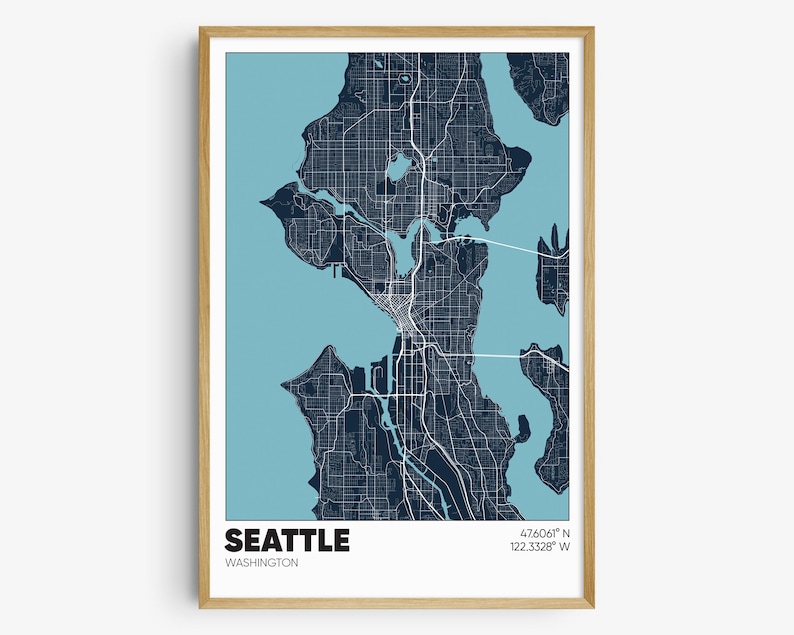 May include: A blue and white map print of Seattle, Washington. The map shows the city's streets and waterways. The text "Seattle, Washington" and the coordinates "47.6061&deg; N 122.3321&deg; W" are printed at the bottom of the map.