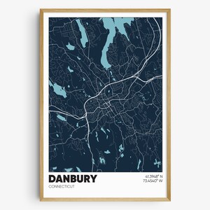 May include: A dark blue map print of Danbury, Connecticut with white lines showing the roads and blue water features. The text "Danbury, Connecticut" and the coordinates "41.3948° N 73.4540° W" are printed at the bottom of the map.