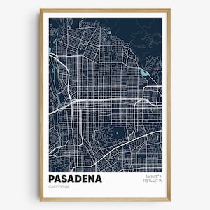 May include: A framed map print of Pasadena, California, featuring a detailed street grid in white against a dark blue background. The city name and coordinates are displayed in a clean, modern font. The print is encased in a light brown wooden frame.