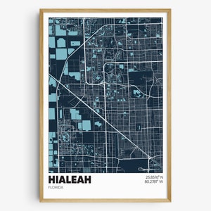 May include: A blue and white map print of Hialeah, Florida. The map shows the city's streets and landmarks. The text "Hialeah, Florida" and the coordinates "25.8576° N 80.2781° W" are printed below the map.