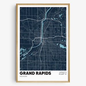 May include: A dark blue map print of Grand Rapids, Michigan with a light blue river and lakes. The city name and coordinates are printed at the bottom of the map.