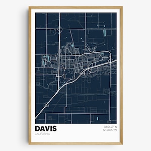 May include: A dark blue map print of Davis, California with white lines showing the streets and roads. The city name "DAVIS" and "CALIFORNIA" are printed in white at the bottom of the map. The coordinates "38.5446° N 121.7405° W" are printed in white at the top right corner of the map.
