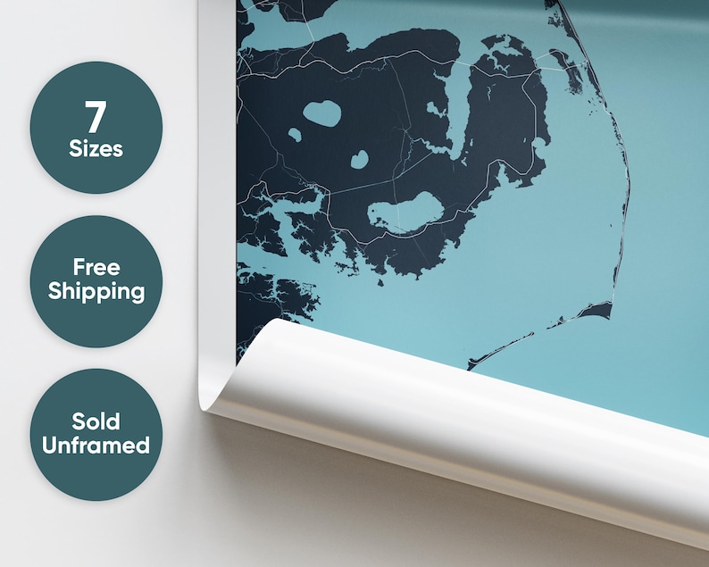 May include: A close-up of a rolled up poster featuring a detailed map of a coastal area. The map is printed on a light blue background with dark blue lines and shapes. The poster is rolled up and partially unrolled, revealing a white edge.
