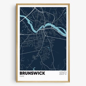 May include: A navy blue map print of Brunswick, Maine with a light blue river and white lines showing the streets. The text "BRUNSWICK" and "MAINE" are at the bottom of the map. The coordinates "43.9140° N 69.9670° W" are also at the bottom of the map.