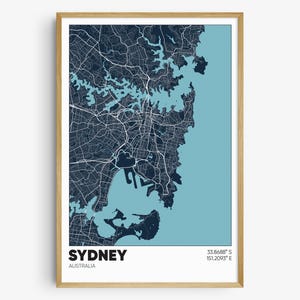 May include: A framed map of Sydney, Australia, with a blue and white color scheme. The map shows the city's streets, waterways, and coastline. The text "SYDNEY" and "AUSTRALIA" are printed below the map, along with the coordinates "33.8688° S 151.2093° E".