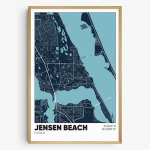 May include: A blue and light blue map print of Jensen Beach, Florida. The map shows the coastline and surrounding area. The text "Jensen Beach, Florida" and the coordinates "27.2545° N 80.2298° W" are printed at the bottom of the map.