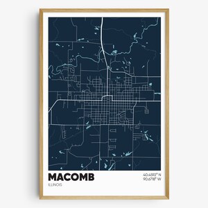 May include: A dark blue map of Macomb, Illinois, with white lines showing the streets and roads. The city name and coordinates are printed in white at the bottom of the map.