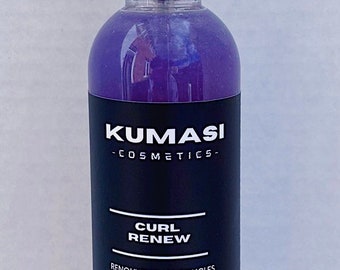 May include: A purple-tinted hair product bottle with a white spray nozzle. The label reads "KUMASI COSMETICS" and "CURL RENEW". It contains flaxseed water and aloe vera juice. The bottle is 8 oz.