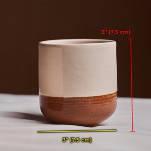 Handcrafted, this ceramic cup measures approximately 3 inches high and 3 inches in diameter, comfortably holds 7 ounces of liquid, ergonomically designed to fit perfectly in your hand