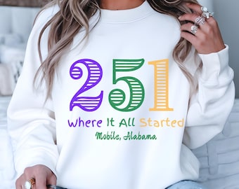 May include: White sweatshirt with a purple, green, and yellow striped design that says "251 Where It All Started Mobile, Alabama".