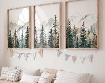 May include: Three framed watercolour paintings of a forest scene with mountains in the background. The paintings are in wooden frames and are hung on a white wall.