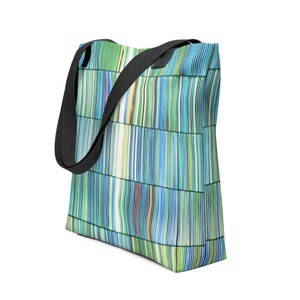 May include: A blue and green tote bag with black straps. The bag has a geometric pattern of vertical lines.