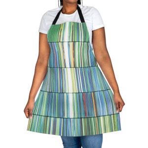 May include: A blue and green striped apron with a black adjustable neck strap. The apron has a white background with colorful vertical stripes.