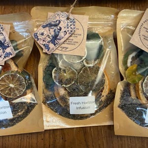 May include: A white ceramic mug with a black handle and the text "But First, Coffee" in a handwritten style. The mug is likely 4 inches tall and holds approximately 12 ounces of liquid.