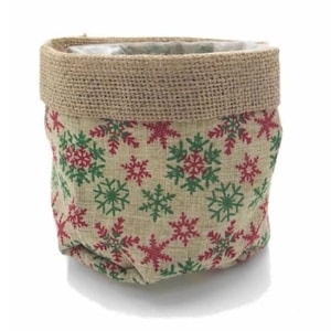 May include: A brown burlap planter with a red and green snowflake pattern. The planter has a plastic liner.