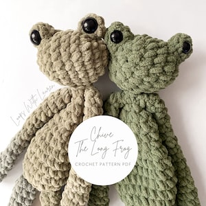 May include: Two crocheted plush toys, a green frog and a brown frog, with black eyes. The toys are made with a fuzzy yarn and are sitting on a white background. The text "Chive The Long Frog CROCHET PATTERN PDF" is on a white circle.