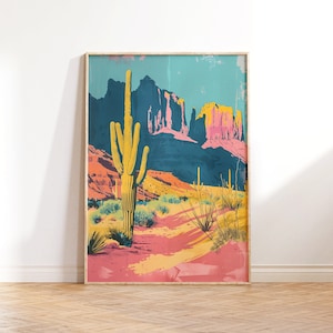 May include: A framed print of a desert landscape with a tall, yellow cactus in the foreground. The background features colorful, rocky mountains and a blue sky.