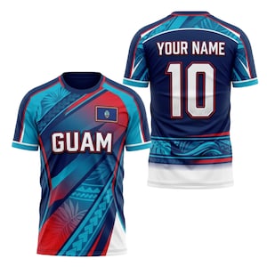 May include: Two short-sleeved jerseys, one front and one back view. The front jersey is blue, red, and teal with the word "GUAM" and a Guam flag. The back jersey is navy blue with the number "10" and the text "YOUR NAME".