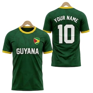 May include: Green Guyana soccer jersey with yellow trim and the word "GUYANA" in white. The front features the Guyana flag. The back displays the number 10 and the words "YOUR NAME" in white.