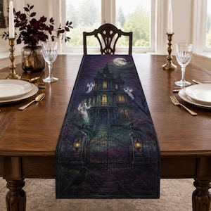 May include: A rectangular table runner featuring a dark, atmospheric scene of a haunted mansion at night. The print displays a large house with glowing windows, a wrought iron gate, flying ghosts, and ravens under a full moon in purple tones.