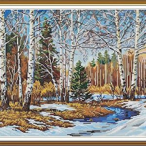May include: Cross-stitch artwork of a winter forest scene. Birch trees with white bark and dark markings stand tall amidst evergreen trees and a snow-covered landscape. A stream of water flows through the scene, reflecting the sky.
