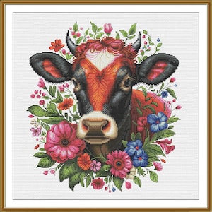 May include: A cross-stitch image of a cow's face, framed by a gold border. The cow has a red and black face, with black horns and ears. It is surrounded by a wreath of pink, red, and blue flowers and green leaves.